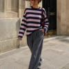 EA-TE567-4 Model wearing the Amelie navy blue and pink striped T-shirt with grey trousers, full-length standing view