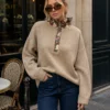 Alix taupe jumper, close front view of floral placket and ruffled neckline