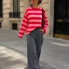 EA-TE567-3 Model wearing the Amelie red and pink striped T-shirt with grey trousers, full-length front view