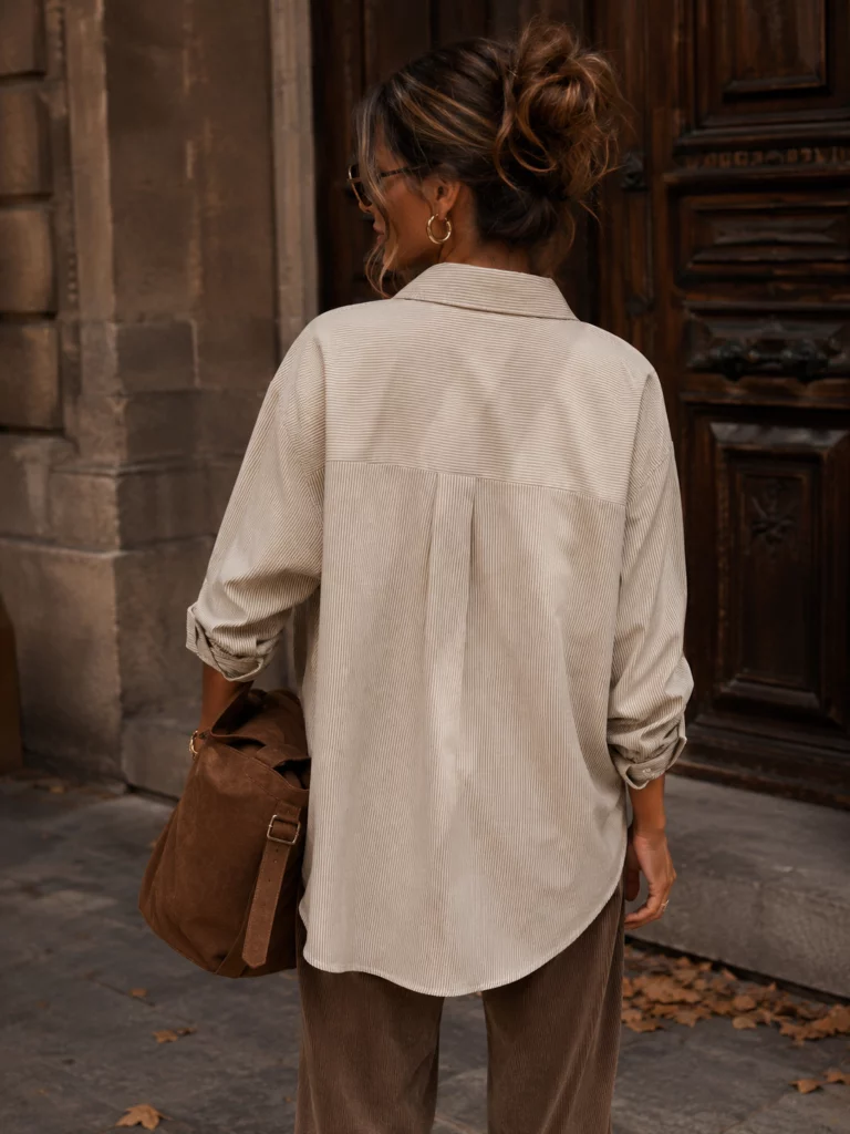 Maelle taupe shirt, back view of centre pleat and curved hem