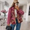 Annora pink and wine striped-sleeve blazer with tropical leaves and leopard figures on a model