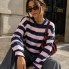 EA-TE567-6 Amelie navy blue and pink striped long-sleeve T-shirt on a seated model, front detail view