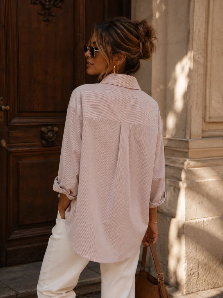Maelle pale pinkish neutral shirt, rear view showing pleat and curved hem