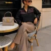 EA-CH161-4 Lison black blouse, seated view showing neckline and cuffs