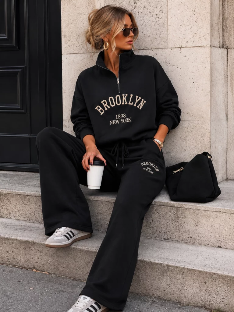 Honoria black co-ord, seated view showing wide trouser legs and drawstring waist